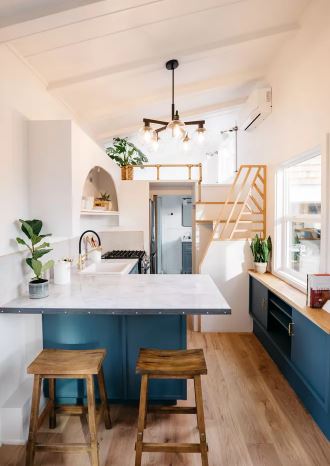 tiny home kitchen: Geometric lines and gold hardware